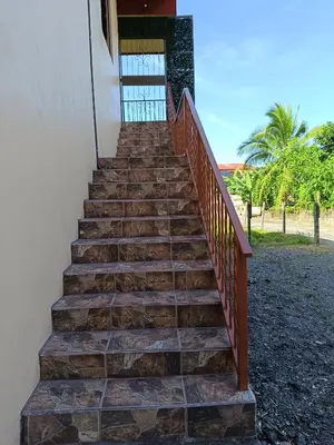 a stairway leading up to a building at Arenal Paradise Lodge in Fortuna