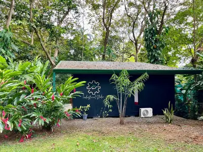 a blue shed with a writing on the side of it at Industrial Studio with private Jacuzzi in Uvita
