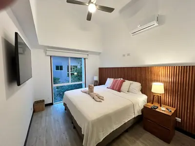 a bedroom with a large bed and a window at Playa Hermosa, Mistico, Surf, Bike, Hike, 4 Hab, Lagos, Familia in Jacó