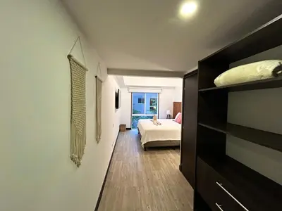 a room with a bedroom with a bed and a window at Playa Hermosa, Mistico, Surf, Bike, Hike, 4 Hab, Lagos, Familia in Jacó