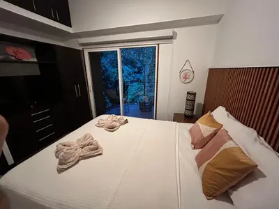 a bedroom with a bed with towels on it at Playa Hermosa, Mistico, Surf, Bike, Hike, 4 Hab, Lagos, Familia in Jacó