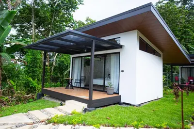 a small house with a black roof at Natura Bungalows in Fortuna