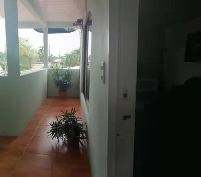 an empty room with a hallway with plants on the floor at Hermoso apartamento en Quepos/ Manuel Antonio. in Quepos