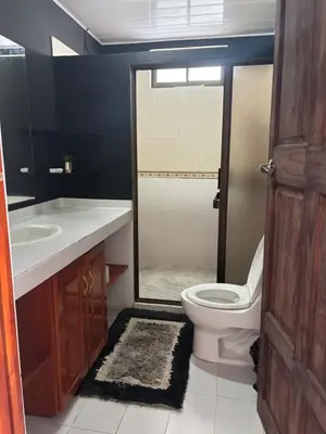 a bathroom with a toilet and a sink at Estudio como en casa in Quepos