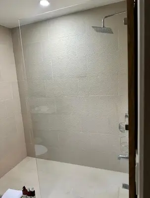 a shower with a glass door in a bathroom at Private Modern Condo by Jac Beach in Jacó