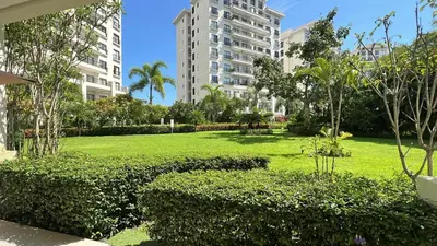 a park in the middle of a city with tall buildings at Private Modern Condo by Jac Beach in Jacó