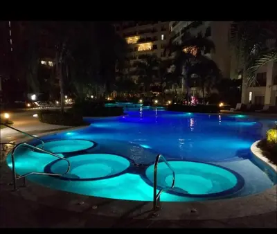 a swimming pool at night with blue lights at Private Modern Condo by Jac Beach in Jacó