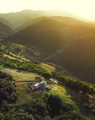 an aerial view of a house in the middle of a mountain at Bus Hotel with HotTube in the middle of mountain in Sarchí