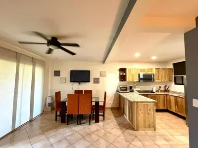 a kitchen with a table and a ceiling fan at Peaceful Bliss Condo inside a 6 pool Complex in Coco