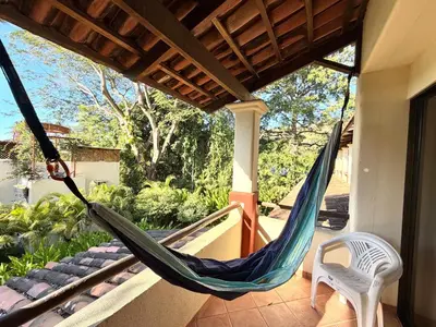 a hammock on the porch of a house at Peaceful Bliss Condo inside a 6 pool Complex in Coco
