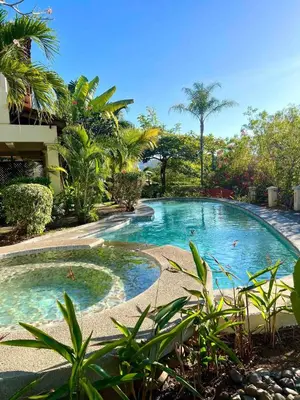 a swimming pool in the middle of a yard at Peaceful Bliss Condo inside a 6 pool Complex in Coco