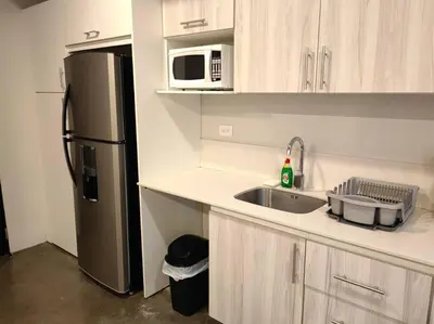 a kitchen with a sink and a refrigerator at 906A URBN Barrio Escalante Estudio con A/C y Parqueo in San José