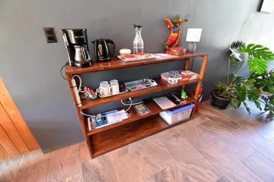 a book shelf with a coffee maker on it at Raya in Matapalo