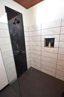 a bathroom with a shower with a glass door at Raya in Matapalo