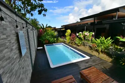 a swimming pool in a yard with a house at Raya in Matapalo