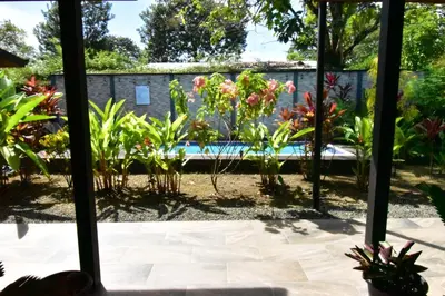 a garden view from the window of a house at Raya in Matapalo