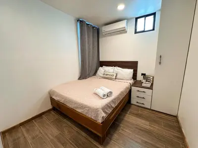 a bedroom with a bed with two towels on it at Villa El Bosque Dorado in Fortuna