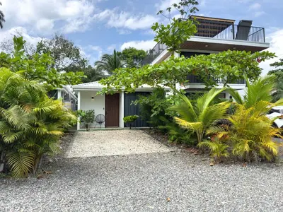 a house with a lot of plants in front of it at Villa El Bosque Dorado in Fortuna
