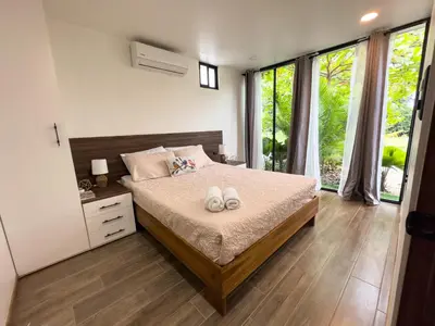 a bedroom with a bed with two towels on it at Villa El Bosque Dorado in Fortuna