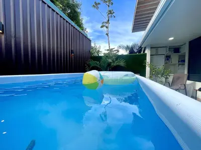 a swimming pool with a yellow ball in a house at Villa El Bosque Dorado in Fortuna