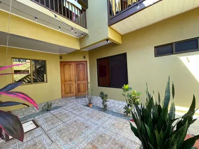 a lobby of a house with plants in front of it at Casa Bella Vista in Quepos
