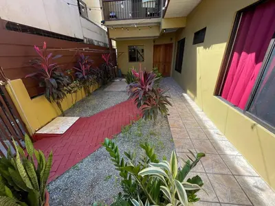an empty hallway of a building with plants at Casa Bella Vista in Quepos