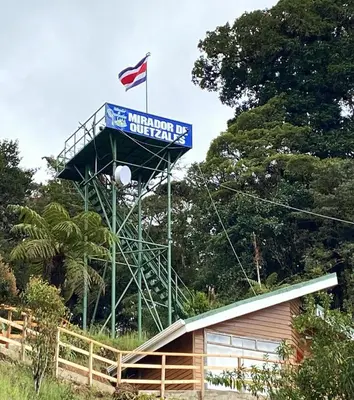 a sign with a flag on top of a building at Hotel Mirador de Quetzales in Providencia