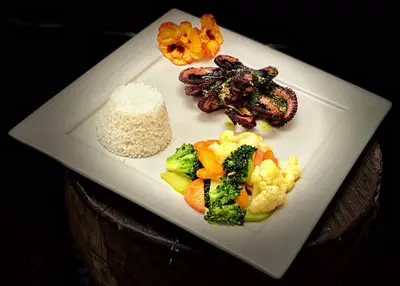a white plate of food with rice and broccoli at Hotel Mirador de Quetzales in Providencia