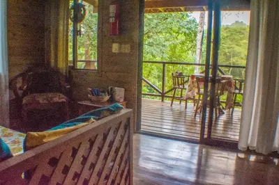 a living room with a porch with a view of a deck at CASITAS GINGER in Quepos