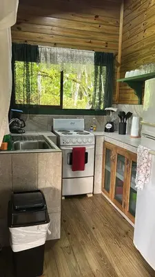 a small kitchen with a stove and a sink at CASITAS GINGER in Quepos
