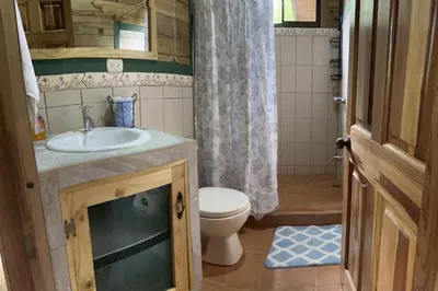 a small bathroom with a sink and a toilet at CASITAS GINGER in Quepos