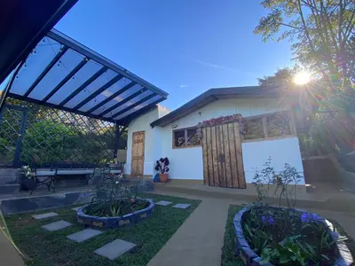 a house with a garden and a patio at Cabañas Tierra Fértil #2 in Montaña