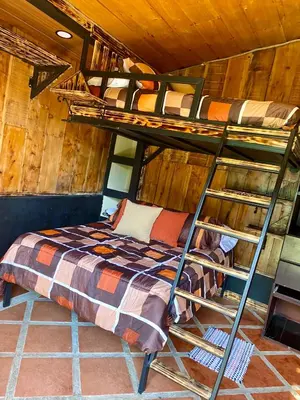 a bedroom with two bunk beds in a cabin at Cabañas Tierra Fértil #2 in Montaña
