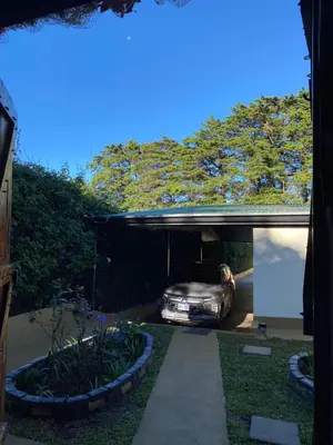 a car is parked under a car garage at Cabañas Tierra Fértil #2 in Montaña