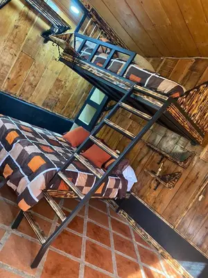 a bedroom with two bunk beds in a attic at Cabañas Tierra Fértil #2 in Montaña