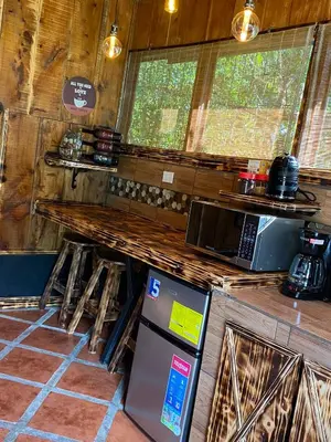 a kitchen with a counter and a refrigerator at Cabañas Tierra Fértil #2 in Montaña
