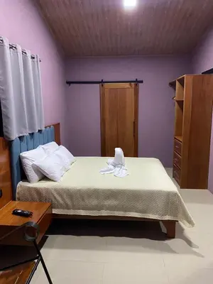 a bedroom with a bed and a dresser with a towel on it at Casa Sios San Luis, Monteverde in Monteverde Costa Rica