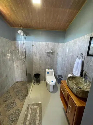 a bathroom with a shower and a toilet and a sink at Casa Sios San Luis, Monteverde in Monteverde Costa Rica