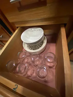a drawer filled with glass dishes and a white plate at Casa Sios San Luis, Monteverde in Monteverde Costa Rica