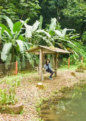 a person sitting on a bench in a wooden structure at Casa Rancho Verde in Monterrey