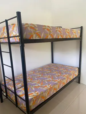a triple bunk bed with a patterned mattress at Casa Zion in San Juanillo