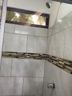 a shower with a glass door with a window at Casa Zion in San Juanillo