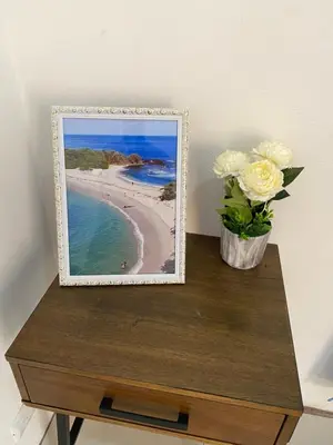 a picture of a beach with a vase of flowers on a table at Casa Zion in San Juanillo