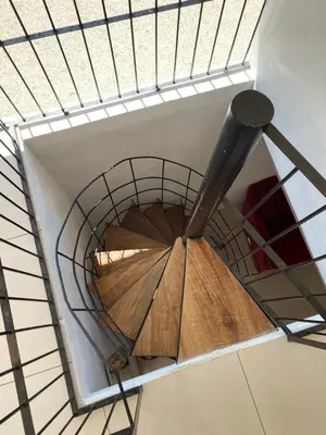 a spiral staircase in a building with a metal at Casa Zion in San Juanillo