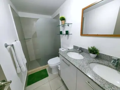 a bathroom with a sink and a toilet and a mirror at 0404 iFreses estudio con Aire Acondicionado y Parqueo in Curridabat