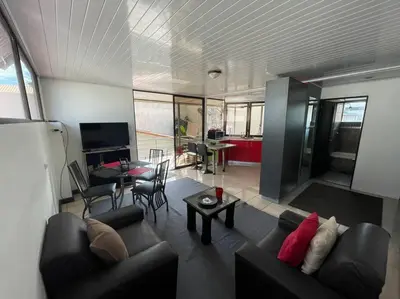 a living room with two couches and a table at Beautiful house in The center of San Ramón in San Ramón