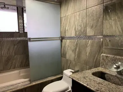 a bathroom with a toilet and a sink and a tub at Beautiful house in The center of San Ramón in San Ramón