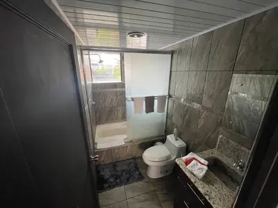 a bathroom with a toilet and a tub and a sink at Beautiful house in The center of San Ramón in San Ramón