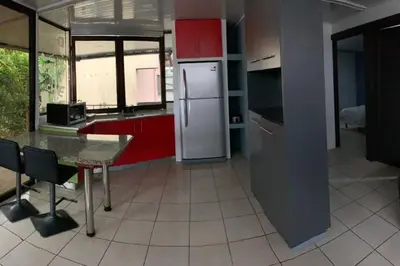 a kitchen with a refrigerator and a table in it at Beautiful house in The center of San Ramón in San Ramón