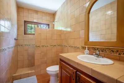 a bathroom with a sink and a toilet at Casa Palma Real in Playa Junquillal